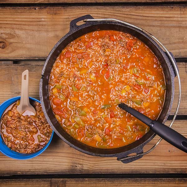 Pot and bowl with delicious, steaming Dutch Oven stuffed bell pepper soup.
