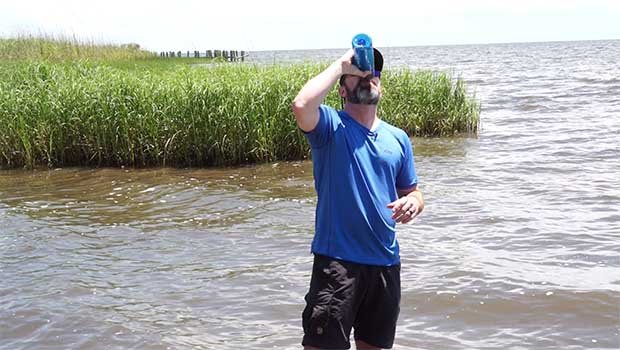 Clint drinks Mississippi River water from a LifeStraw GO Bottle during 50 Campfires Field Trip: Great River Road.