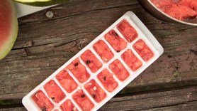 Ice cube tray filled with chopped, pureed watermelon flesh, frozen and ready to drop into any beverage that could benefit from a hint of watermelon.