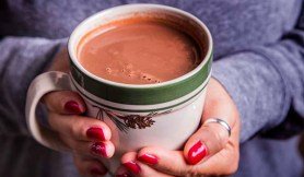 Warming hands on mug of Red Wine Hot Chocolate - The Perfect Camping Cocoa, made with Black Box Cabernet Sauvignon.