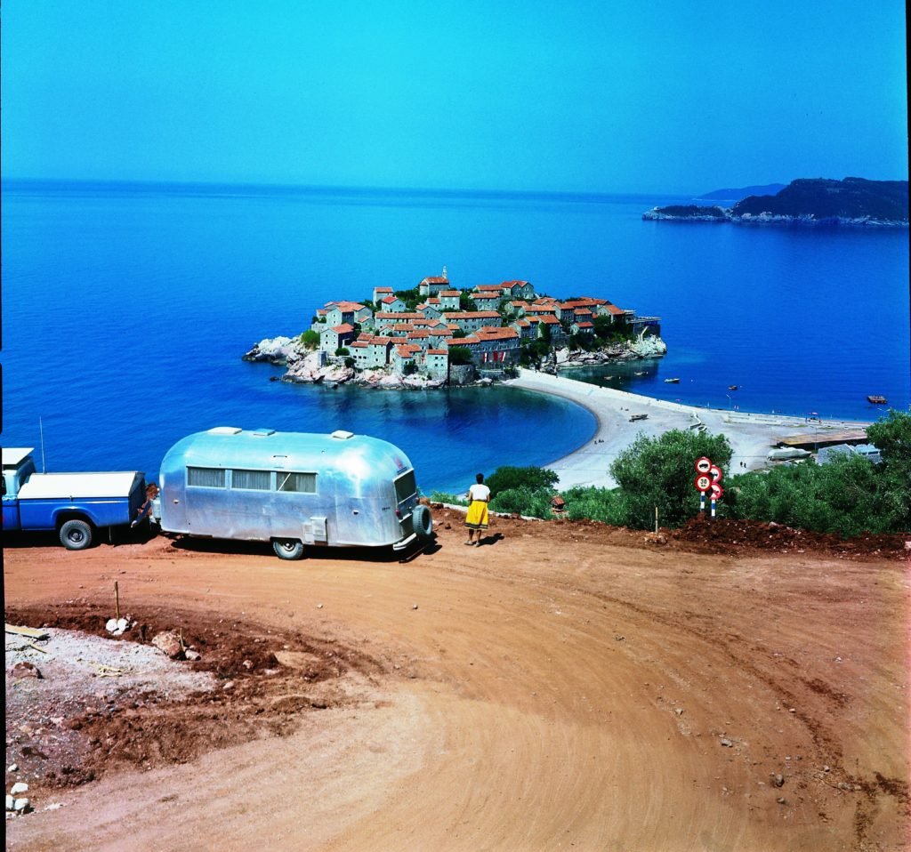 An Airstream allows you to travel to places that you couldn’t reach by plane or train. In this photo, a traveler observes Sveti Stefan, an island about 4 miles southeast of Budva that is connected by causeway to the mainland in Montenegro. 