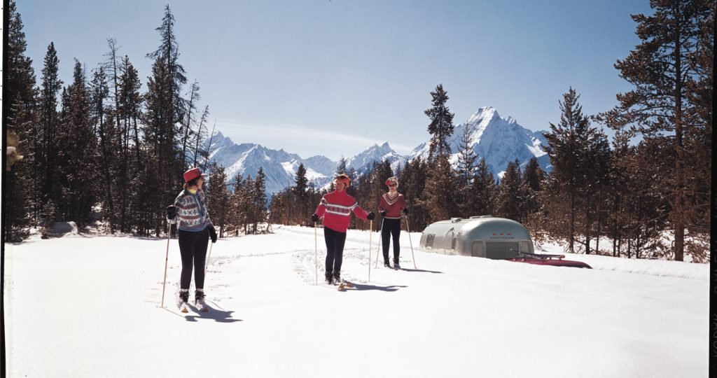 To make cold weather touring possible, the Airstream trailer offers extra-snug insulation and a great heating system. This couple took their Airstream to the mountains for a ski trip. 