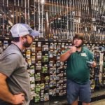 Clint gets a lesson in bass fishing from an associate at Bass Pro Shops at the Pyramid in Memphis, Tennessee prior to trying his luck at Natchez State Park later in the 50 Campfires Field Trip: Great River Road.