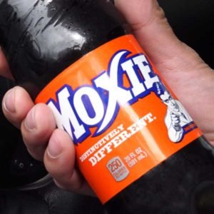 Close up of a label on a bottle of Moxie - the official soft drink of Maine. Even they admit it's an acquired taste.