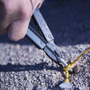 Victorinox Swiss Army Swisstool BS pulling a tent stake.