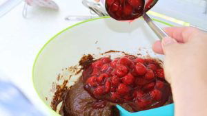 Adding can of cherry pie filling to the batter for campfire birthday cake cupcakes in citrus halves.