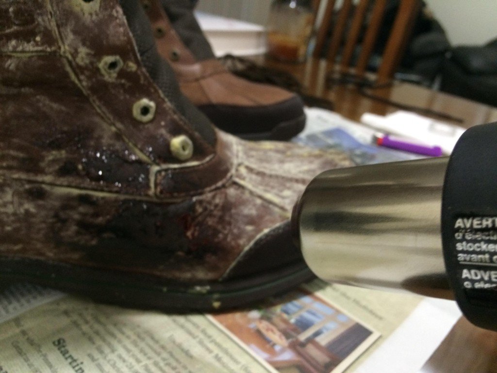 Use the heat gun to melt the wax, while using the toothbrush to smooth out the melting wax. It should absorb right into the boot. The toothbrush might melt a little, which is fine. Hold the heat gun just far enough to melt the wax without melting any synthetic parts of the boot, or burning any fur. 