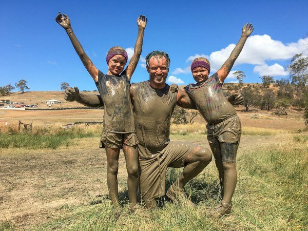 Father with children after completing a mud run