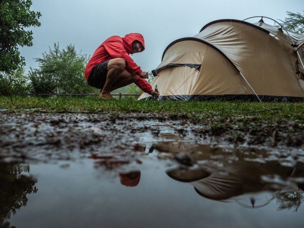Man caught in a rainstorm while camping