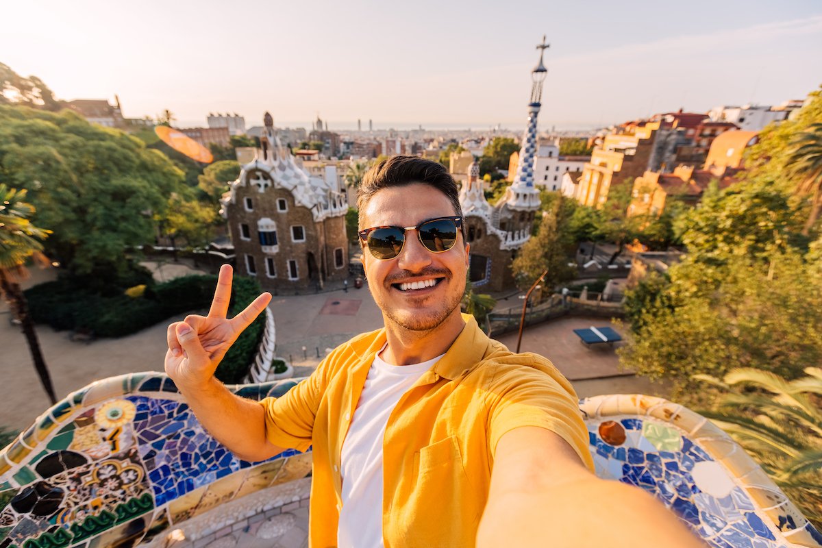 Selfie of a young smiling man in sunglasses in Barcelona, Spain