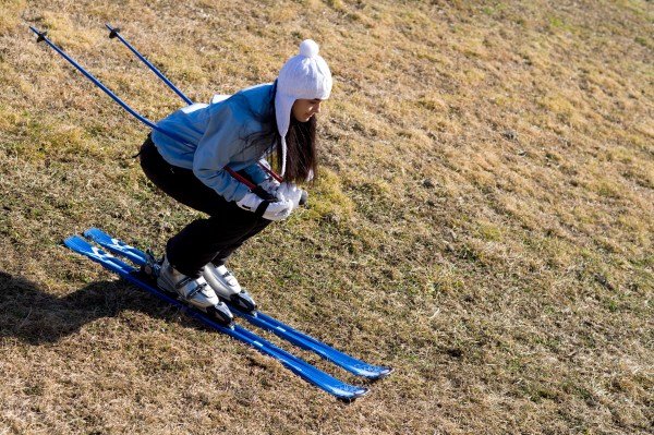 young woman skiing on meadow
