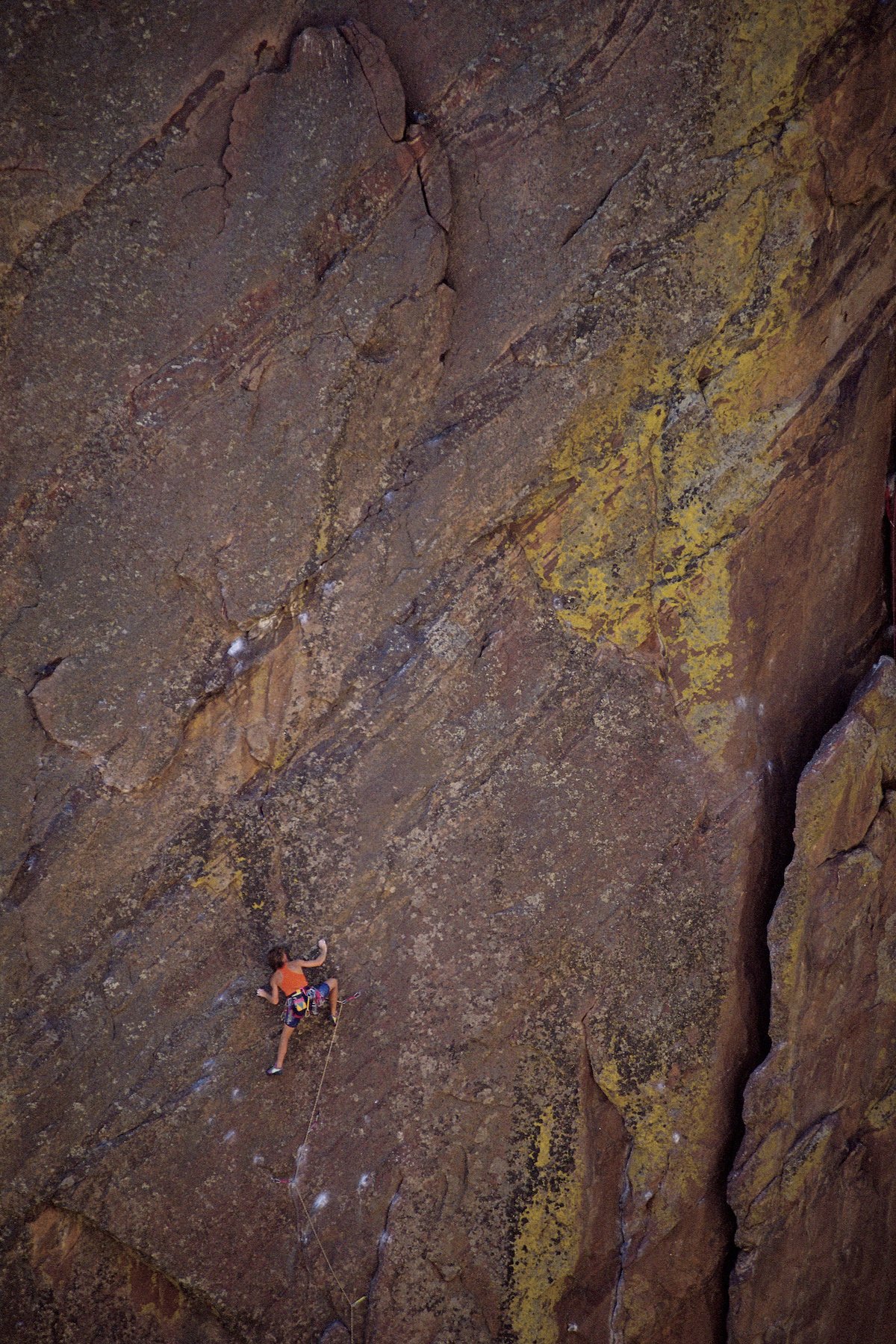 Rock climber ascending cliff in Eldorado Canyon , Colorado