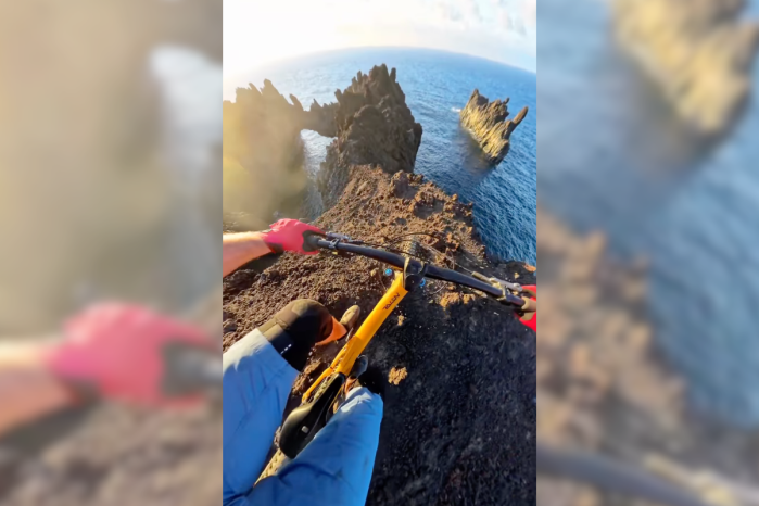 mountain biker cliff over ocean